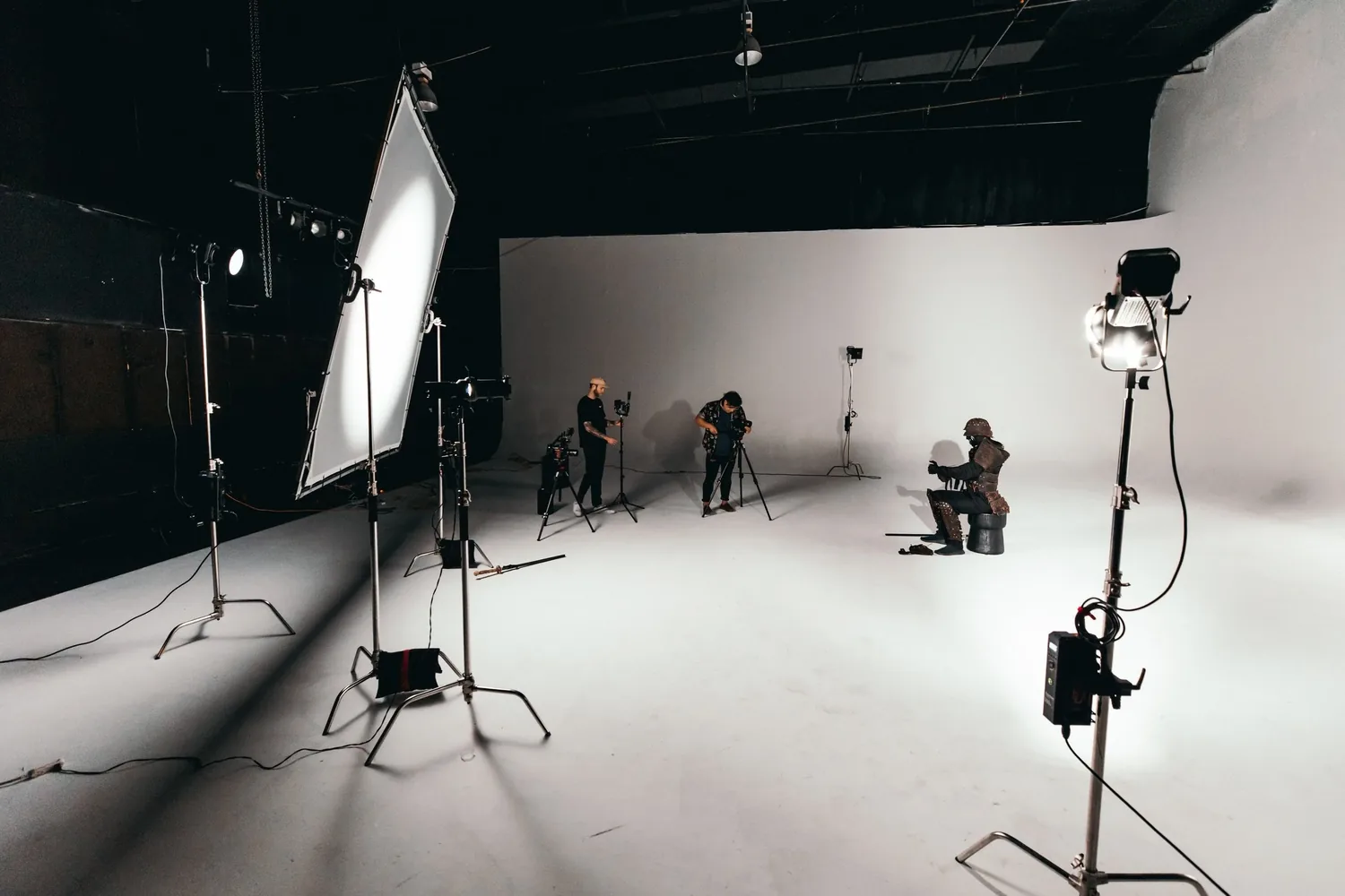Film lights and a white cyclorama on a blacked-out soundstage during the Ibaraki shoot