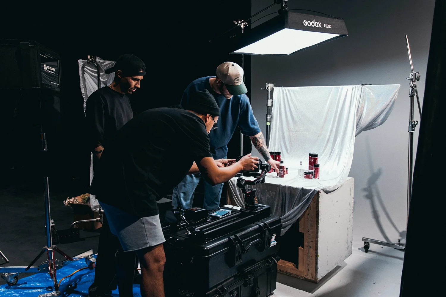 Kyle Loftus Studios crew lighting a product table under a softbox on the Lasio shoot